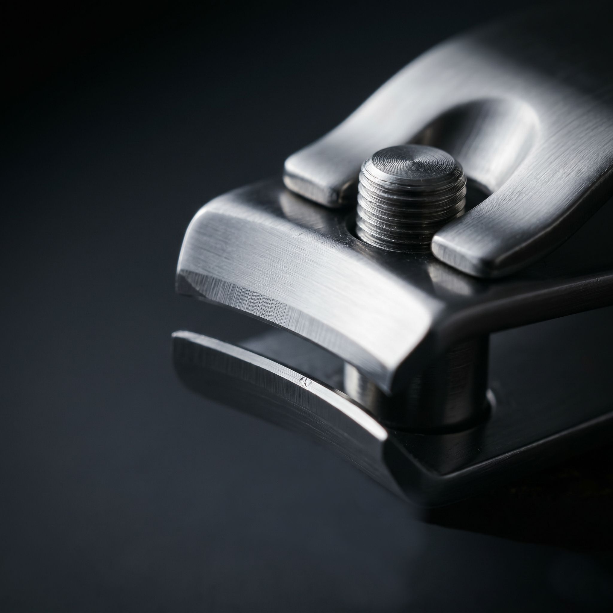 Extreme macro shot of a brushed steel jaws of a Scharfmeister nail clipper